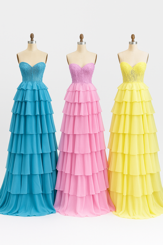 Three colorful tiered formal dresses on mannequins.