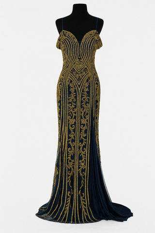 Black and gold beaded evening gown on a mannequin.