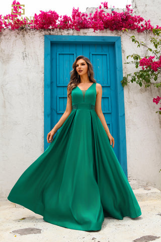 Woman in green gown by blue door