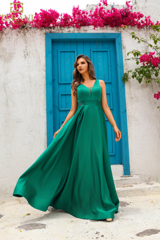Woman in green dress in front of blue door