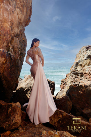 Blush gown by Terani Couture on rocks near ocean