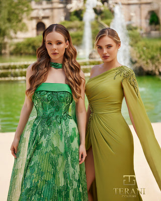 Two women in green Terani dresses near fountain