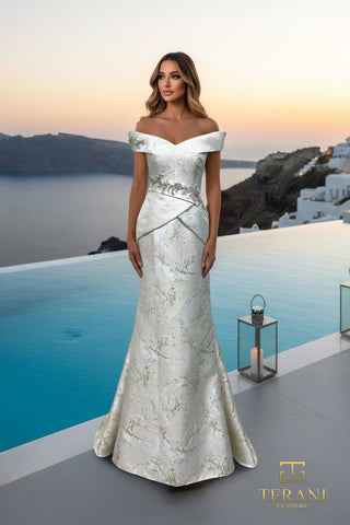 Woman in white off-the-shoulder gown by pool at sunset.