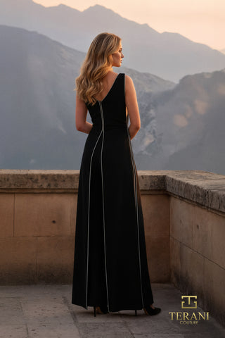 Woman in black gown with back detail, mountains in background.