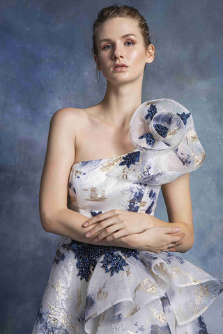 Woman in a white and blue floral dress.