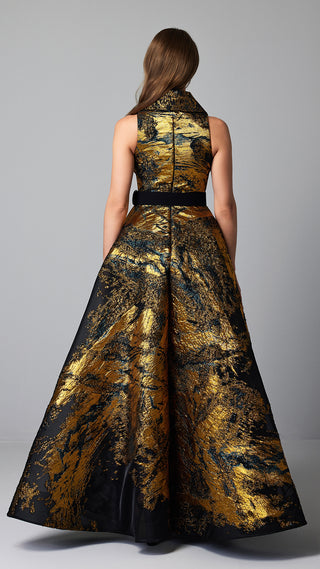 Woman in gold and black patterned gown.