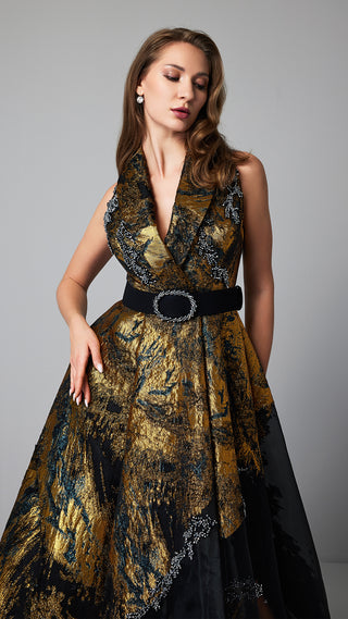 Woman in gold and black patterned gown.