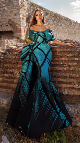 Woman in blue and black patterned gown.