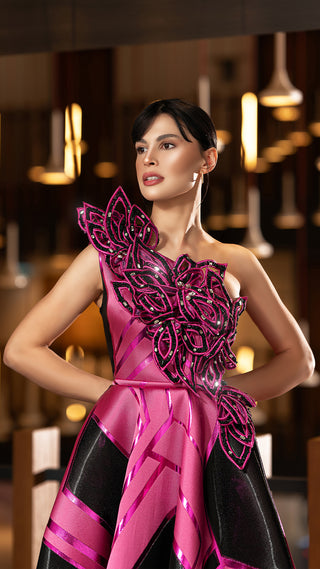 Woman in a pink and black formal gown.