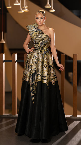 Woman in a black and gold formal gown.