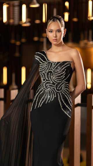 Woman in a black, one-shoulder gown.