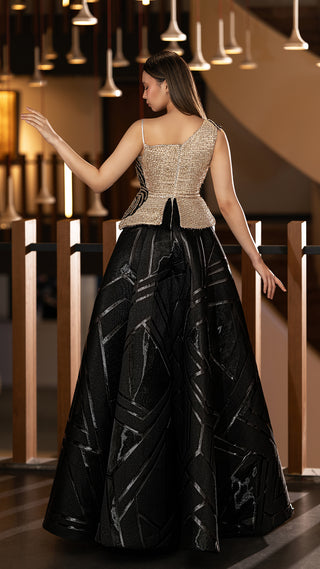 Woman in formal gold and black gown.