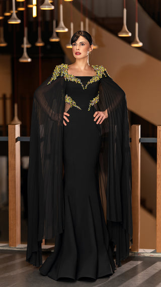 Woman in black gown with cape.