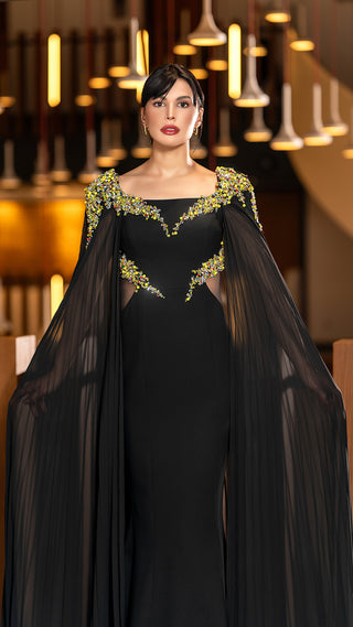 Woman in black gown with cape.