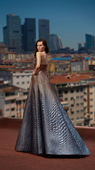 Woman in formal gown, cityscape background.
