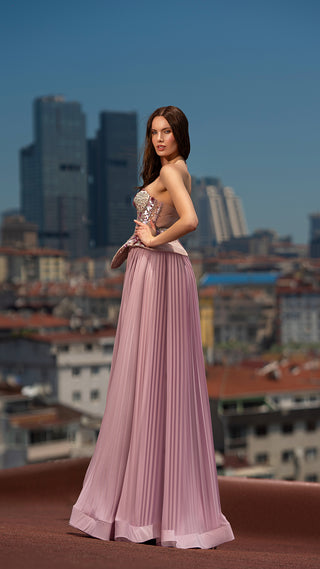 Woman in formal gown, cityscape background.