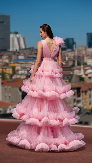 Woman in pink ruffled gown.