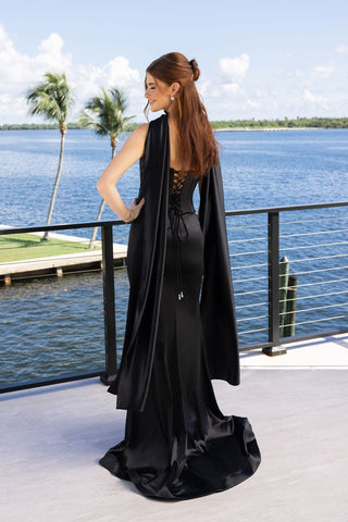 Woman in black dress by the water