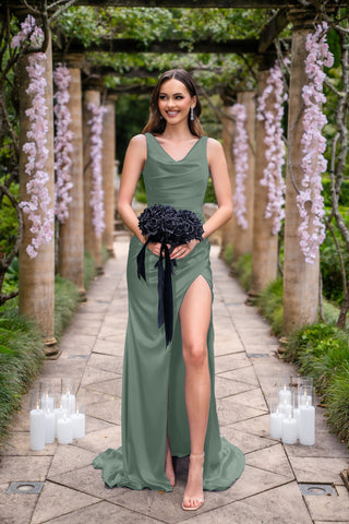 Amelia Fern in green dress holding black bouquet