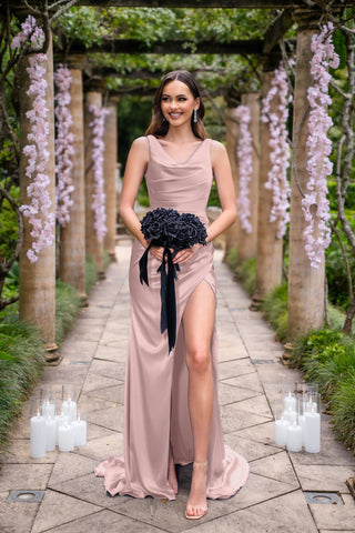 Amelia in pink dress with bouquet, outdoors.
