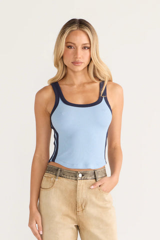 Woman in light blue tank top and jeans