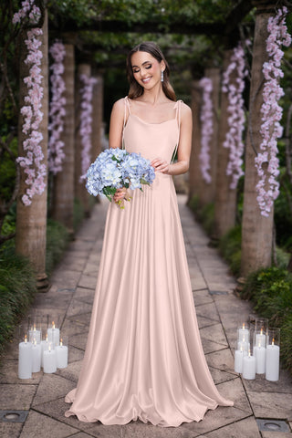 Glenda in light pink gown holding blue bouquet