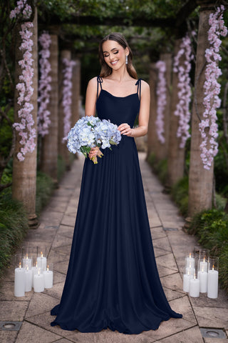 Glenda in navy blue dress holding flowers