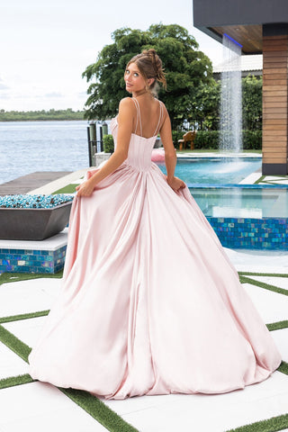 Woman in pink formal gown by water