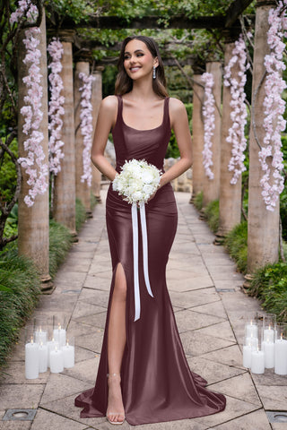 Isadora Burgundy gown with slit, holding bouquet