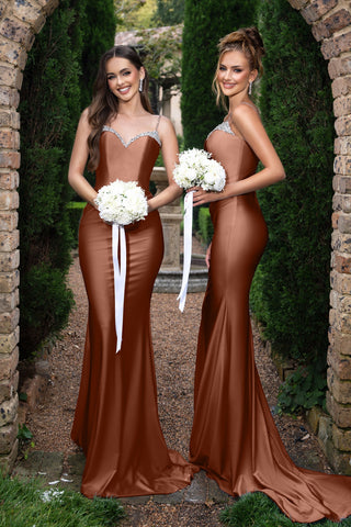 Louise wearing Desert Rose dress with bouquet