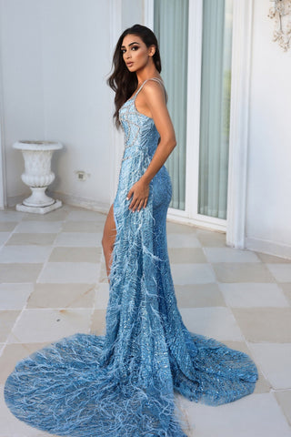 Woman in PS23415 Blue sequin gown with high slit