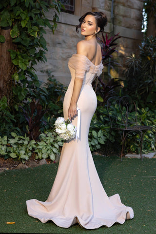 Woman in blush off-the-shoulder gown with bouquet