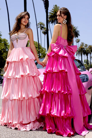 Two women in pink and hot pink tiered formal gowns