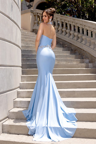 Woman in blue formal gown on stairs