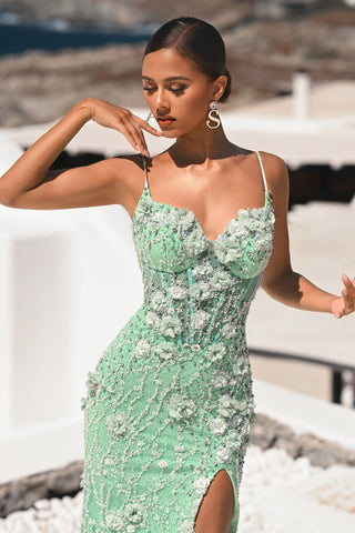 Mint floral embellished gown on a woman