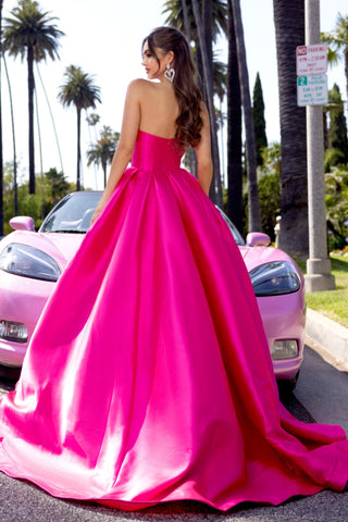 Hot pink strapless gown, PS25306, with a pink car in the background.