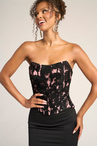 Black and nude strapless corset top on woman