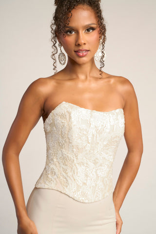 Cream strapless corset top on model