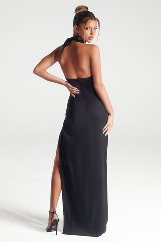 Woman in black halter dress, back view