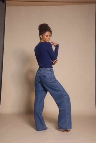 Woman in blue top and jeans, screenshot from Oct 30, 2025