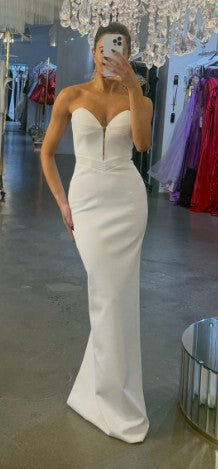 Woman in white formal dress, screenshot from July 7, 2025.