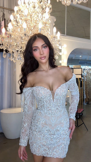 Woman in beaded off-shoulder dress, WhatsApp image