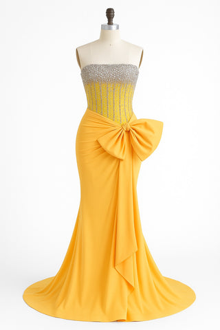 Yellow strapless gown with large bow on mannequin