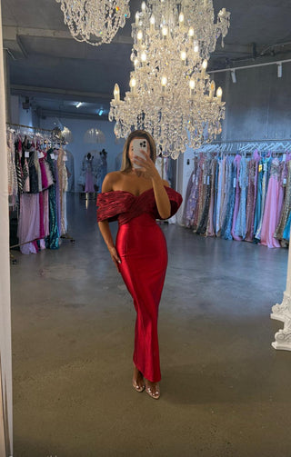 Woman in red dress in boutique, July 14, 2025
