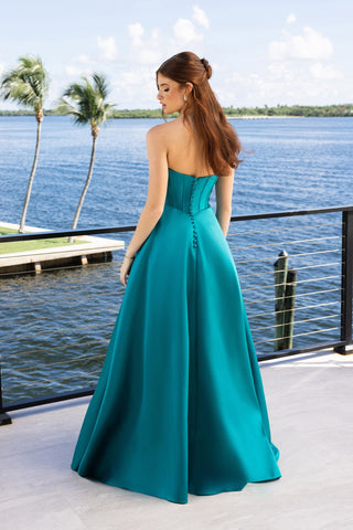 Teal strapless formal gown XO124, overlooking water.