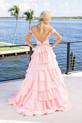 Elegant pink ruffled formal gown with open back.