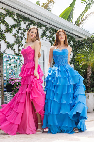 Two women in pink and teal ruffle gowns
