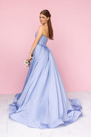 Woman in a light blue formal dress with bouquet