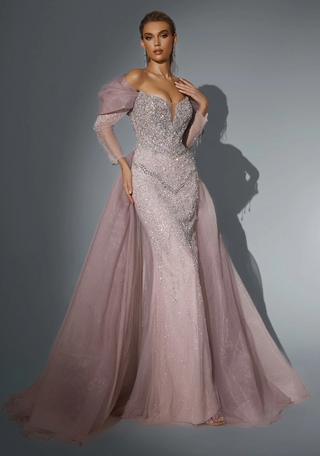 Woman in a beaded, long, lavender gown with a train.