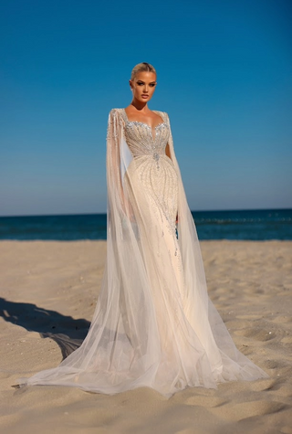 Woman in wedding dress on beach.